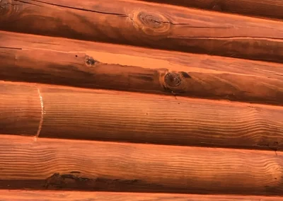 Stained log cabin wall