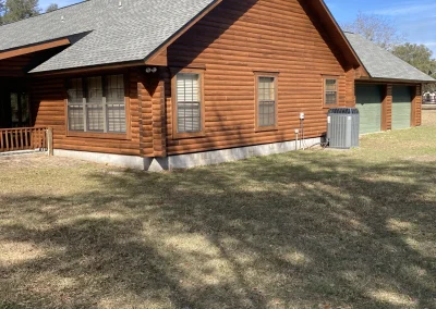 Log cabin with multiple garages and windows