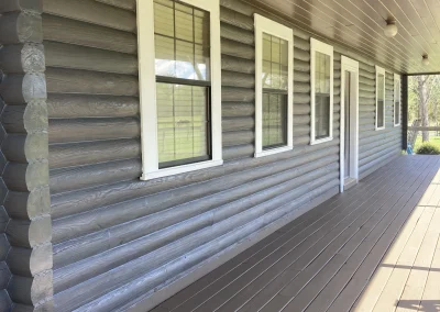 Freshly painted log cabin wall and deck